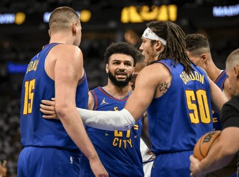 Aaron Gordon (50) of the Denver Nuggets calls for teammates Nikola Jokic (15), Jamal Murray (27), and Michael Porter Jr. (1) to huddle during the first quarter against the Minnesota Timberwolves at Target Center in Minneapolis